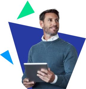 A corporate man looks off to the right with an ipad in his hands.